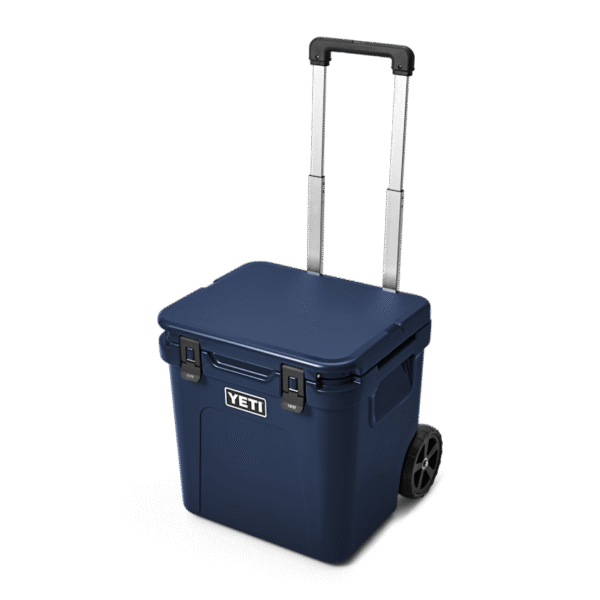 YETI Roadie® 48 Wheeled Cooler W 220022 site studio Hard Coolers Roadie 48 Navy 3qtr Front Handle Up 7795 Primary B 2400x2400 yeticoolershop.com